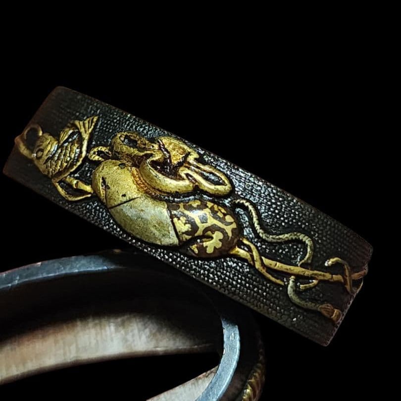 A metal fitting made of red copper, adorned with a fish scale pattern, depicting a fishing scene: (1 of 6)