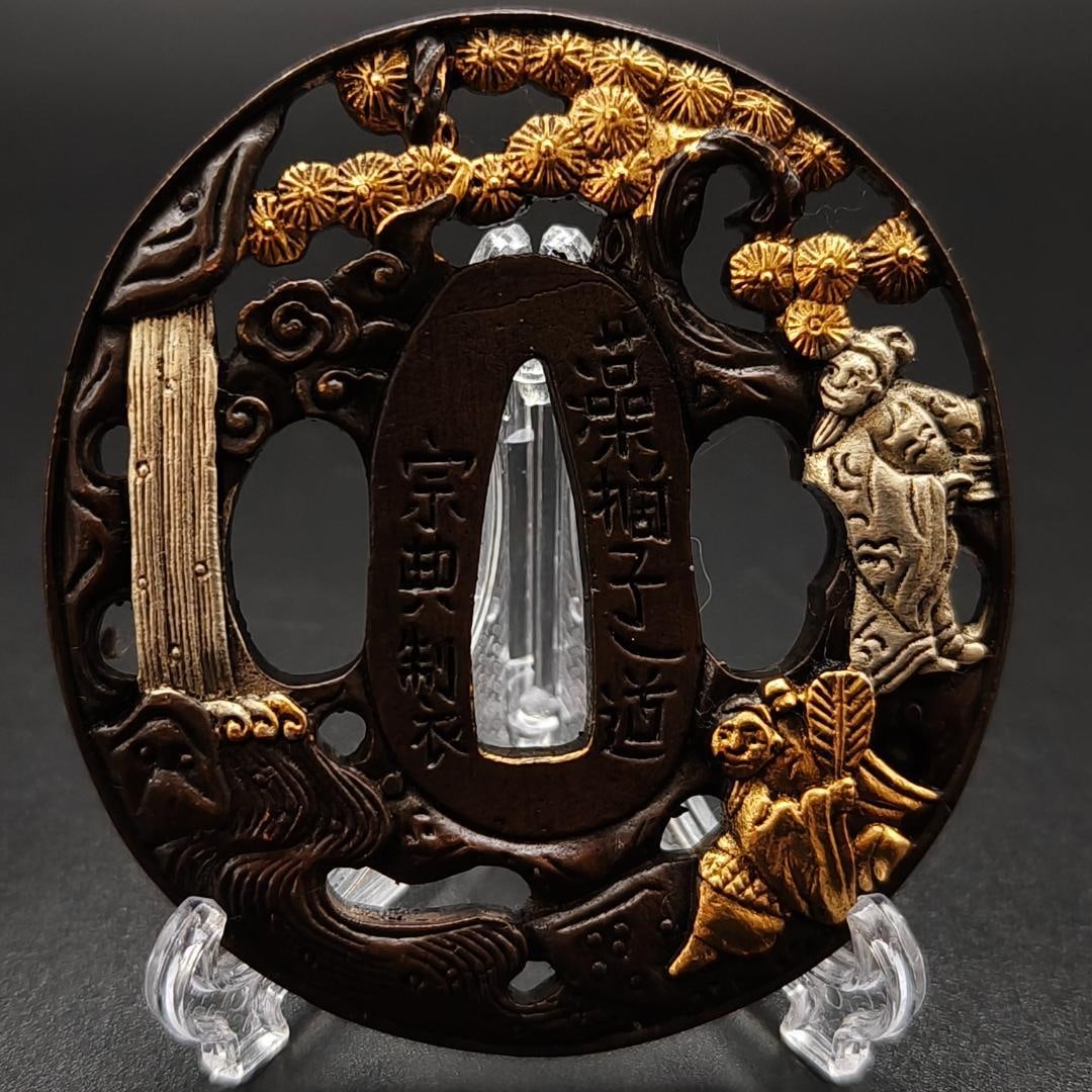 Tsuba: "Yujin Shuyu-zu" (Friends on an Autumn Outing) Bronze Base Gold and Silver Plating: Tsuba: "Friends on an Autumn Outing" Tsuba Stand, Tsuba, Copper Base, Craftsmanship, Gold and Silver Plating, Japanese Sword Fittings Material: Copper Weight: 170 grams Thickness: 8 millimeters
