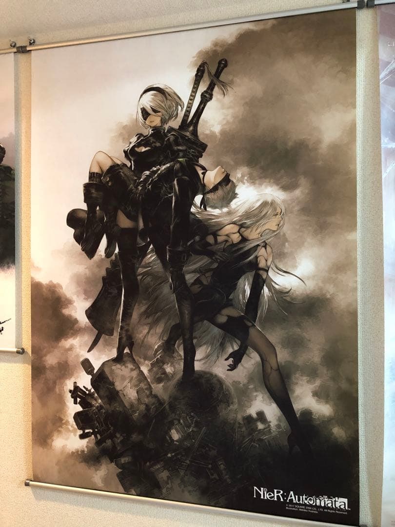 Tapestry Poster of "Nier: Automata": This is a rather large wall-hanging poster. This is a tapestry of "Nier: Automata". It was once hung on the wall, but there is no noticeable fading. The corners of the poster are slightly bent, but ov