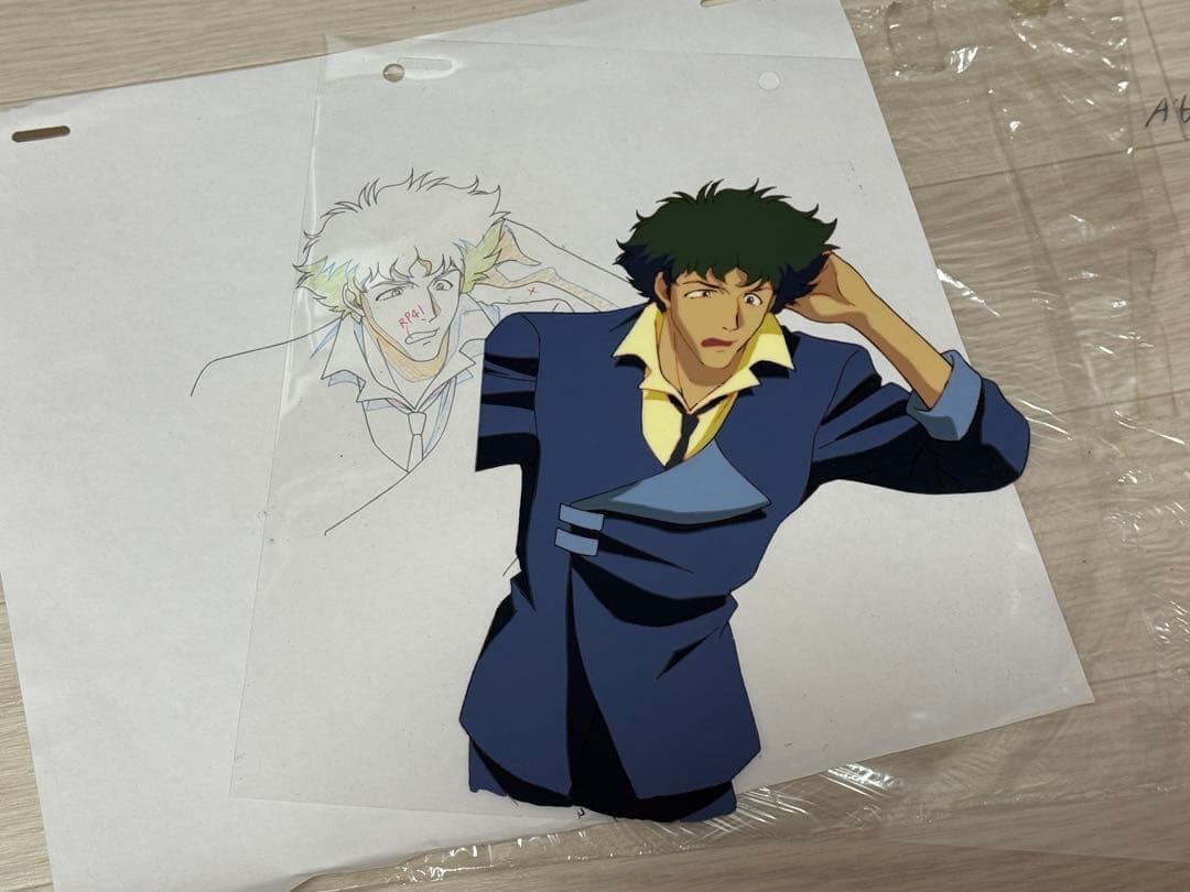 Cel Animation from "Cowboy Bebop": A cel from "Cowboy Bebop" featuring Spike Spiegel. Ink marks (white) from the time can be seen on the left edge of the cel, otherwise, the overall condition is quite good. The scent of the ink remains