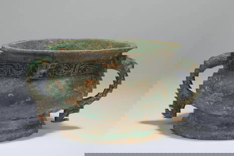 A bronze phoenix and glutton patterns burner, Western Zhou dynasty: H: 4.5 in. (11.5 cm) D: 6.7 in. (17 cm)