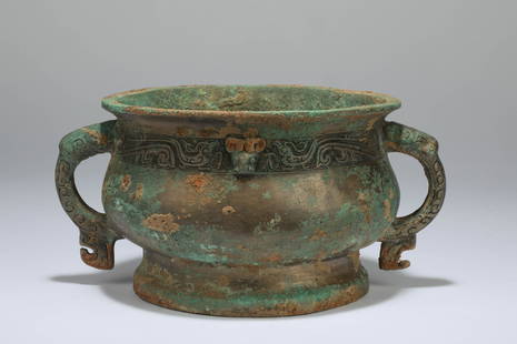 A bronze phoenix and glutton patterns burner, Western Zhou dynasty: H: 4.5 in. (11.5 cm) D: 6.7 in. (17 cm)