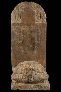 A carved Buddha statue stele, Tang dynasty: H: 29.9 in. (76 cm) D: 18.9 in. (48 cm)