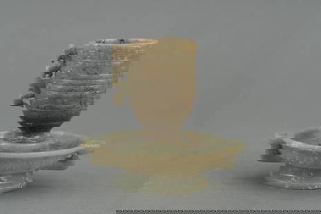 A coiled dragon pattern jade cup, Han dynasty: H: 3.7 in. (9.5 cm) D: 4.1 in. (10.5 cm)