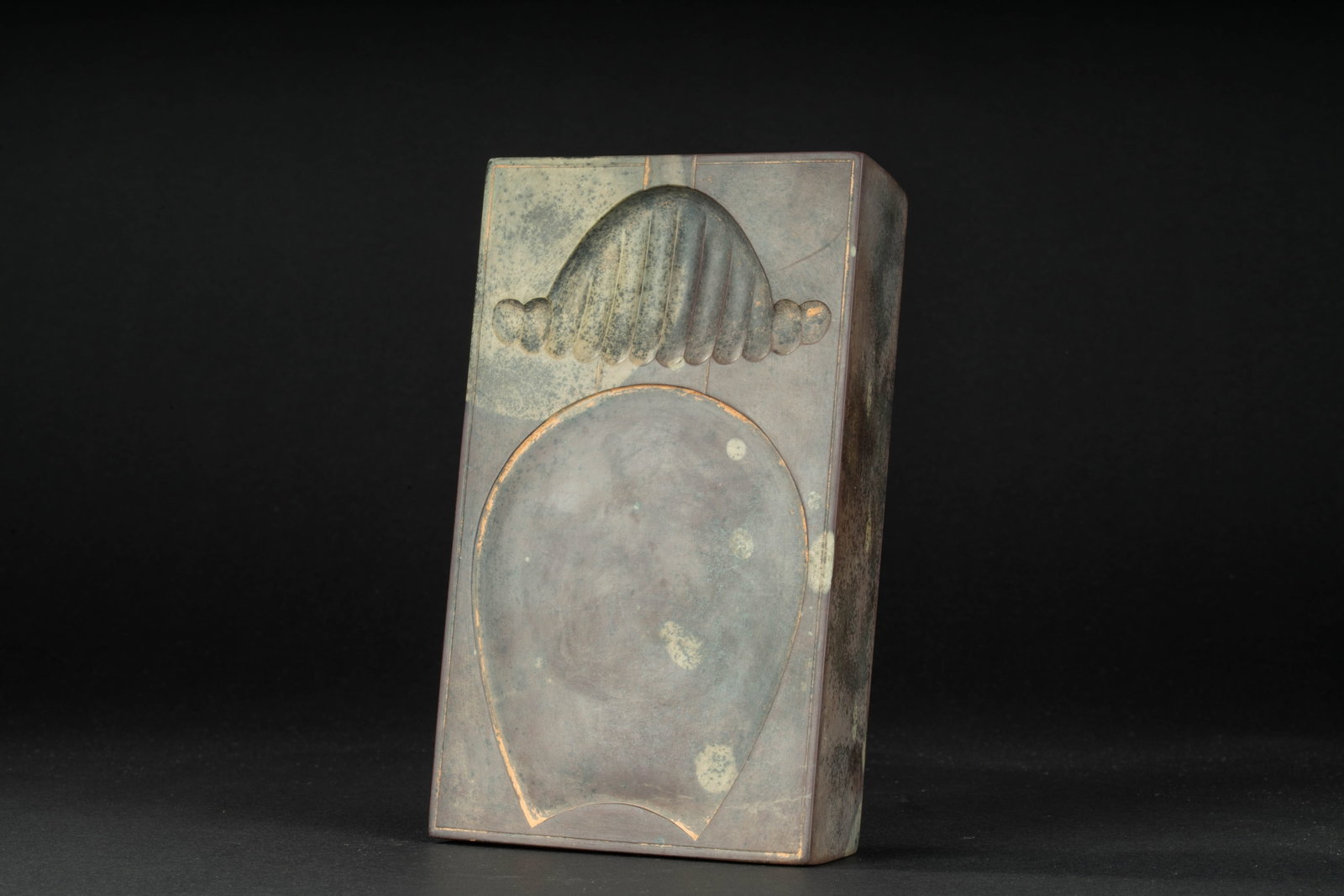 A inkstone, Tang dynasty: H: 1.4 in. (3.6 cm) L: 6.6 in. (16.8 cm) D: 4 in. (10.3 cm)