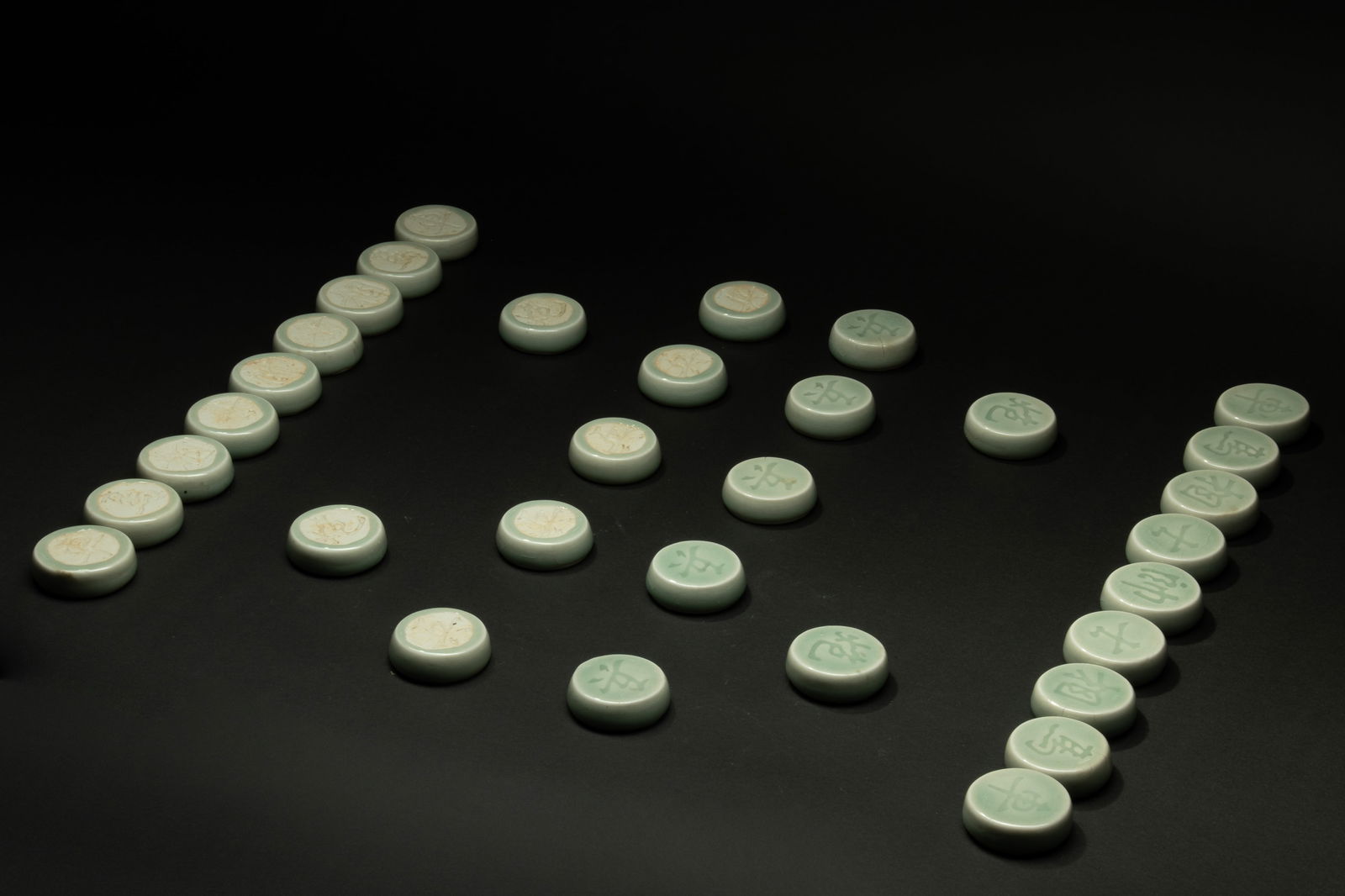 A set of celadon Chinese chess, Republic of China era: H: 0.6 in. (1.5 cm) D: 1.8 in. (4.7 cm)