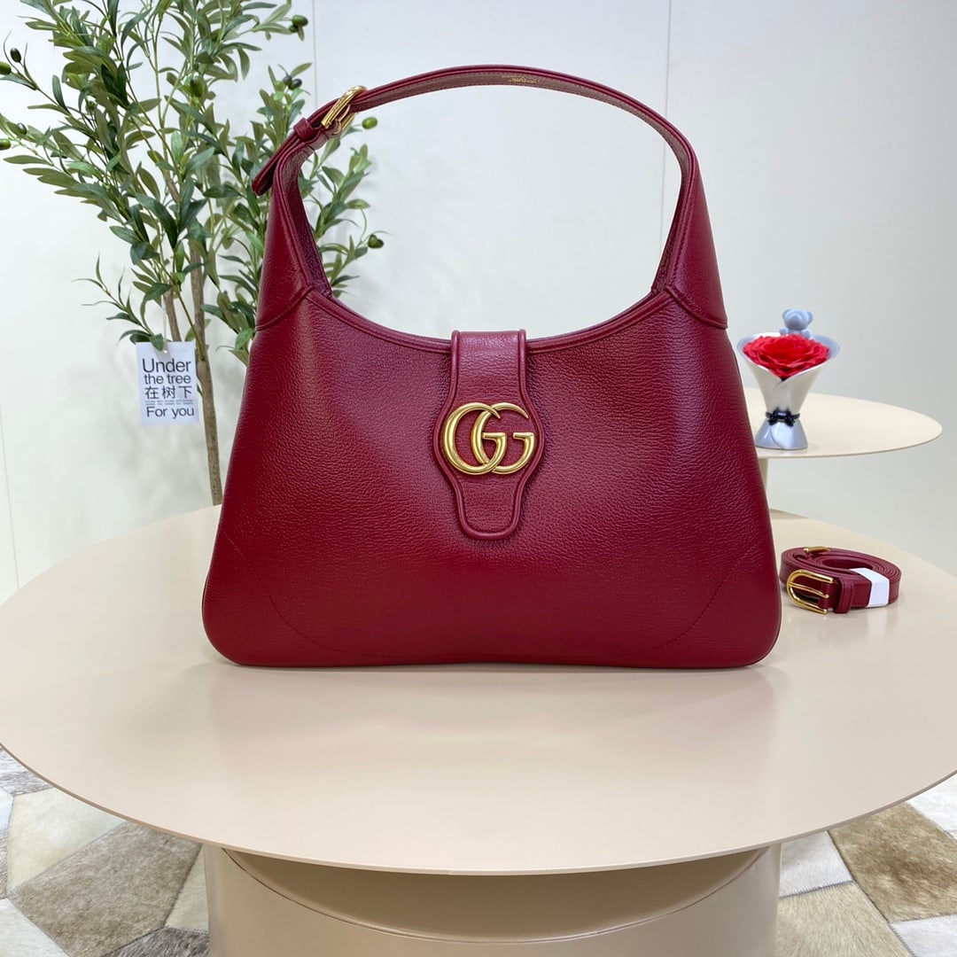 GUCCI Aphrodite: The GUCCI Aphrodite medium crescent bag in Gu Cosmogonie red was showcased at the historic Castel Monte in Italy. The runway show intertwined aesthetic elements from different eras and locations, conn