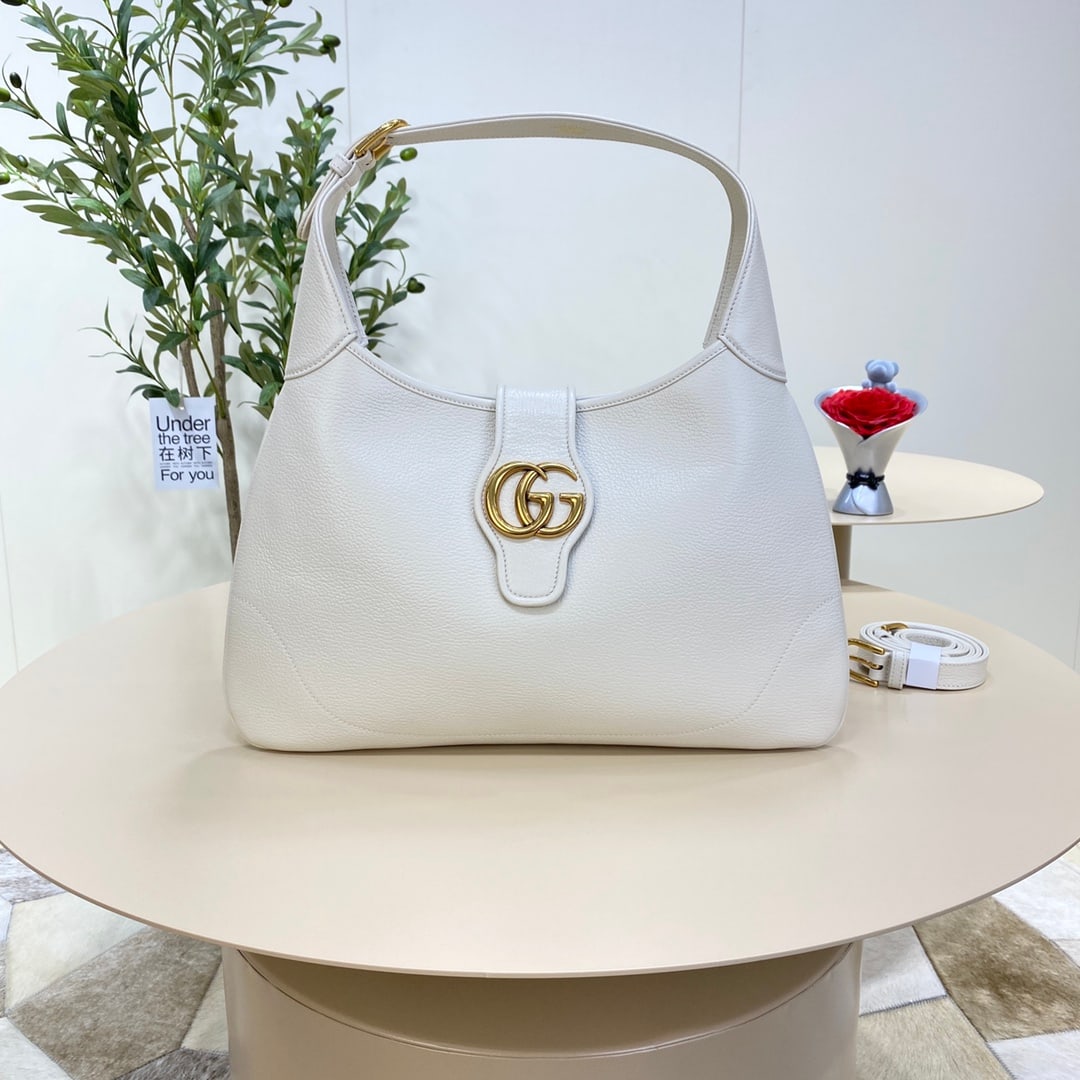 GUCCI Aphrodite: The GUCCI Aphrodite medium crescent bag in white (Gu Cosmogonie) was unveiled at the historic Monte Fortress in Italy. The show showcased aesthetic elements from different eras and geographical locati