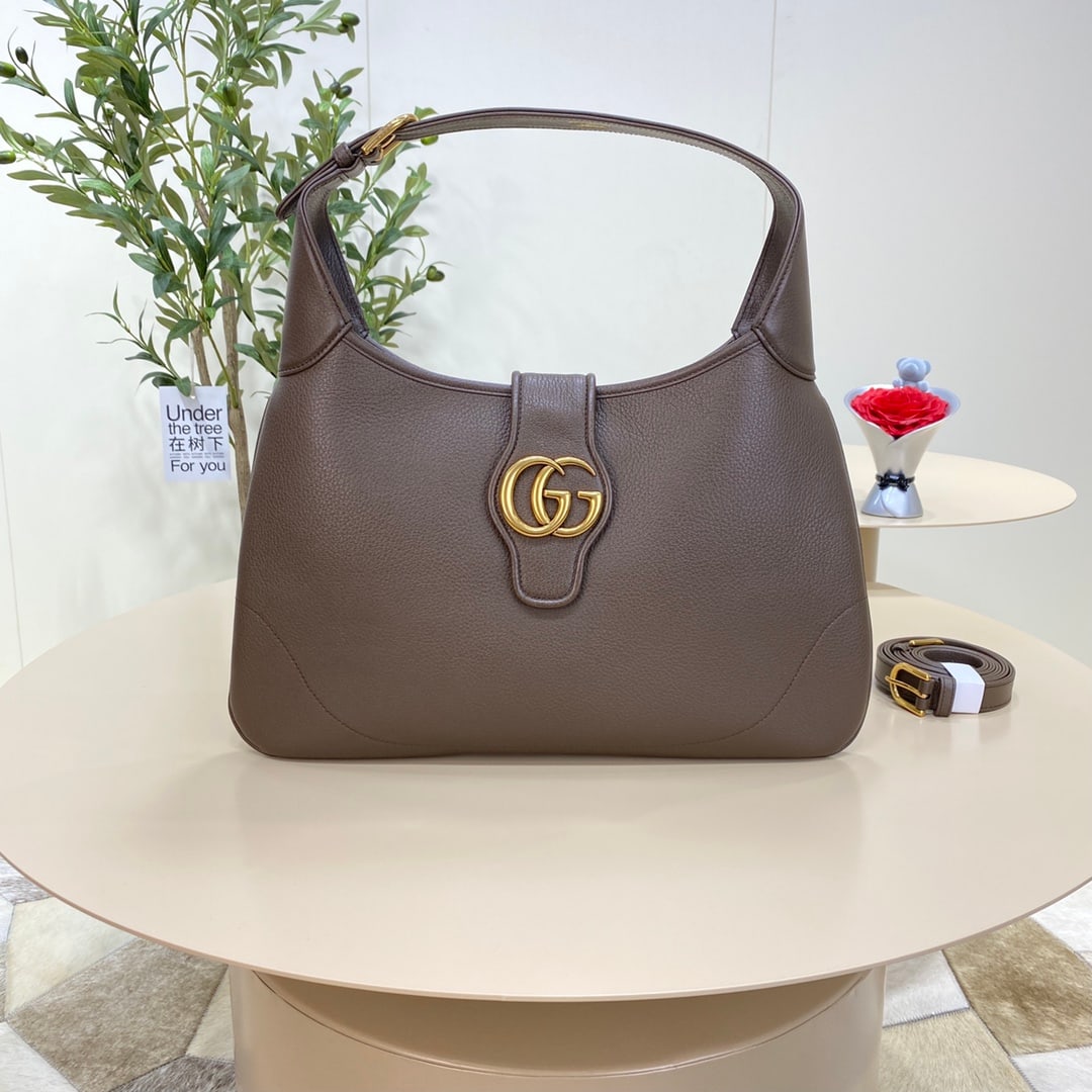 GUCCI Aphrodite: The GUCCI Aphrodite medium crescent bag (Gu Cosmogonie) from the GUCCI Aphrodite collection debuted at the historic Castel Monte in Italy. The runway show intertwined aesthetic elements from different