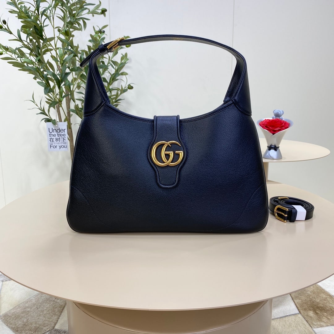 GUCCI Aphrodite: The GUCCI Aphrodite medium crescent bag in black (Gu Cosmogonie) was showcased at the historic Monte Fortress in Italy. The runway show intertwined aesthetic elements from different eras and geographi