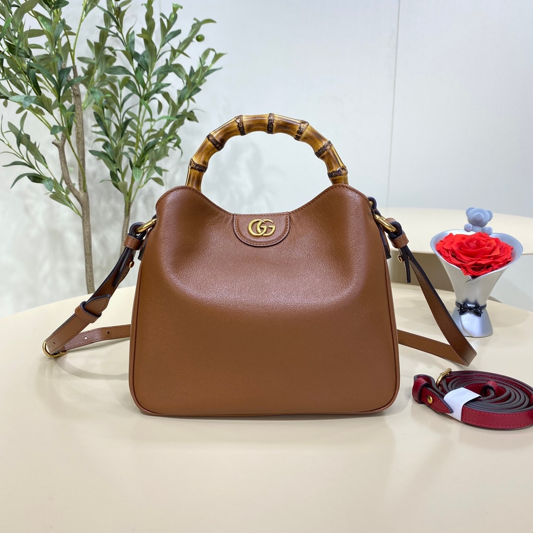 GUCCI Diana: The GUCCI Diana Small Bamboo Bucket Bag in brown cleverly combines two of the brand's most recognizable elements the bamboo handle and the double G hardware giving the entire design a unique charm. Cr