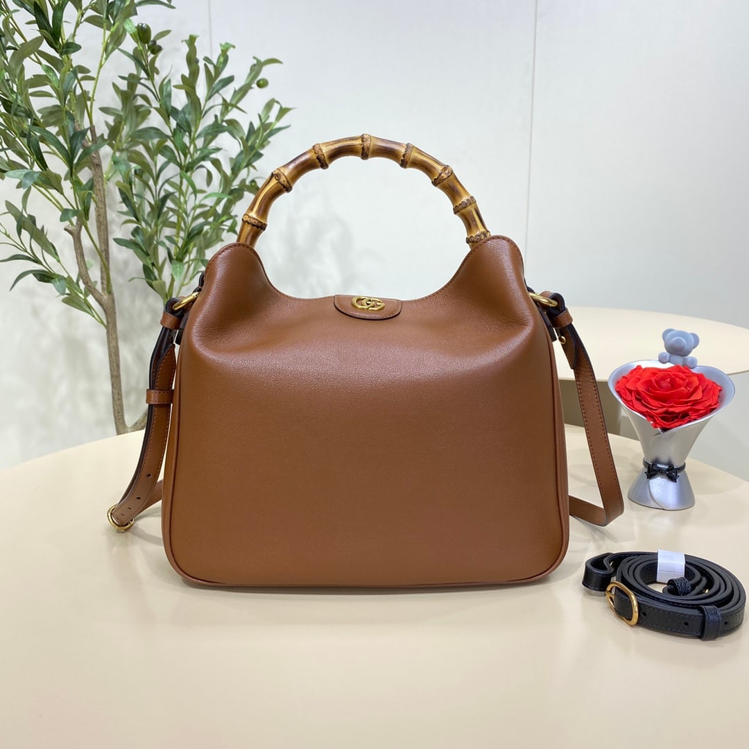 GUCCI Diana: The GUCCI Diana medium bamboo bucket bag in brown cleverly combines two of the brand's most recognizable elements the bamboo handle and the double G hardware giving the entire design a unique charm. T