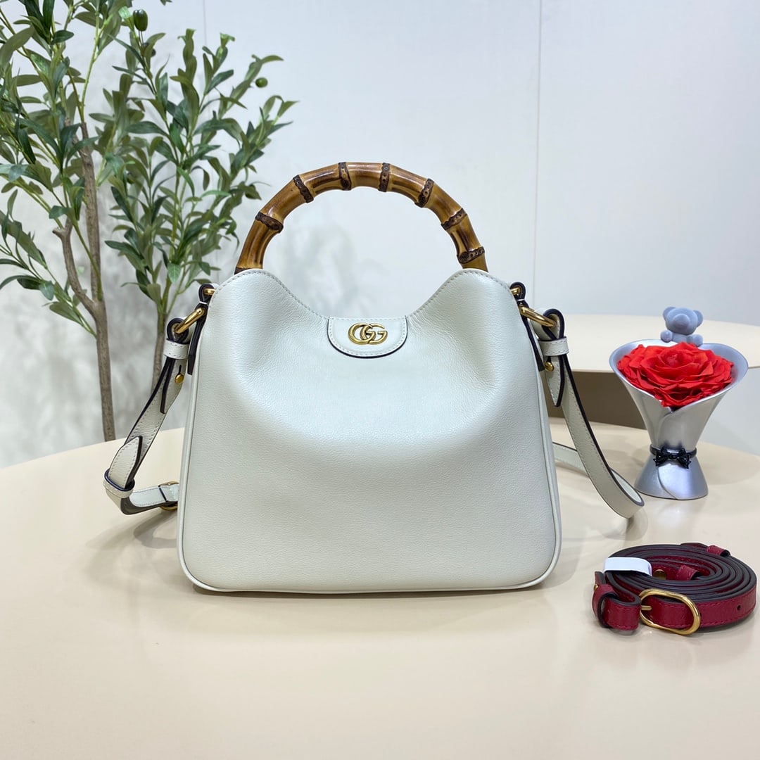 GUCCI Diana: The white GUCCI Diana Small Bamboo Bucket Bag cleverly combines two of the brand's most recognizable elements the bamboo handle and the double G hardware giving the entire design a unique charm. Craft