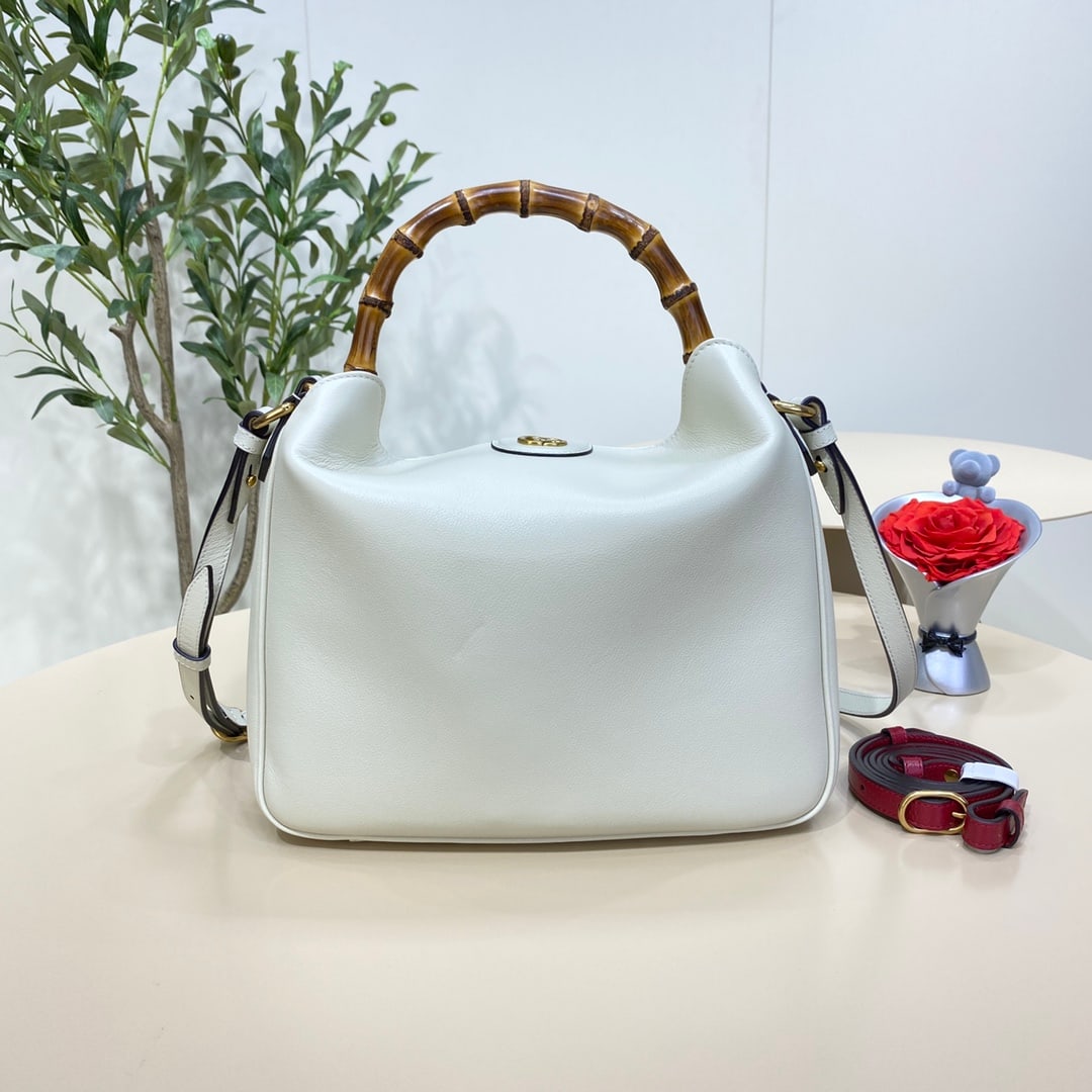 GUCCI Diana: The GUCCI Diana medium bamboo bucket bag in white cleverly combines two of the brand's most recognizable elements the bamboo handles and the double G hardware giving the entire design a unique charm. 