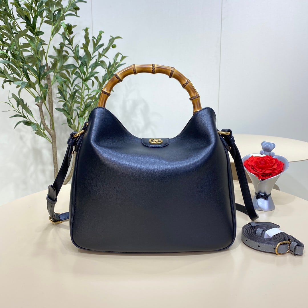 GUCCI Diana: The GUCCI Diana Medium Bamboo Bucket Bag in Black cleverly combines two of the brand's most recognizable elements the bamboo handles and the double G hardware giving the entire design a unique charm. 