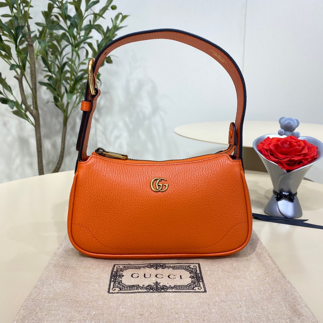 GUCCI Aphrodite: The GUCCI Aphrodite Mini Shoulder Bag in Orange pays homage to the popular styles of the late 1990s and early 2000s, reinterpreting them with a fresh silhouette. It blends classic design with trendy c