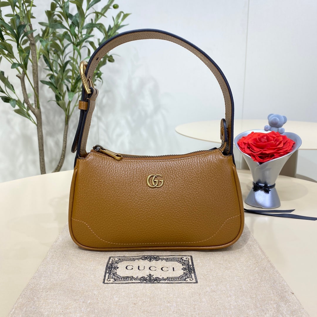GUCCI Aphrodite: The GUCCI Aphrodite mini shoulder bag in brown pays homage to the popular styles of the late 1990s and early 2000s, reinterpreting them with a fresh silhouette. It blends classic design with trendy co