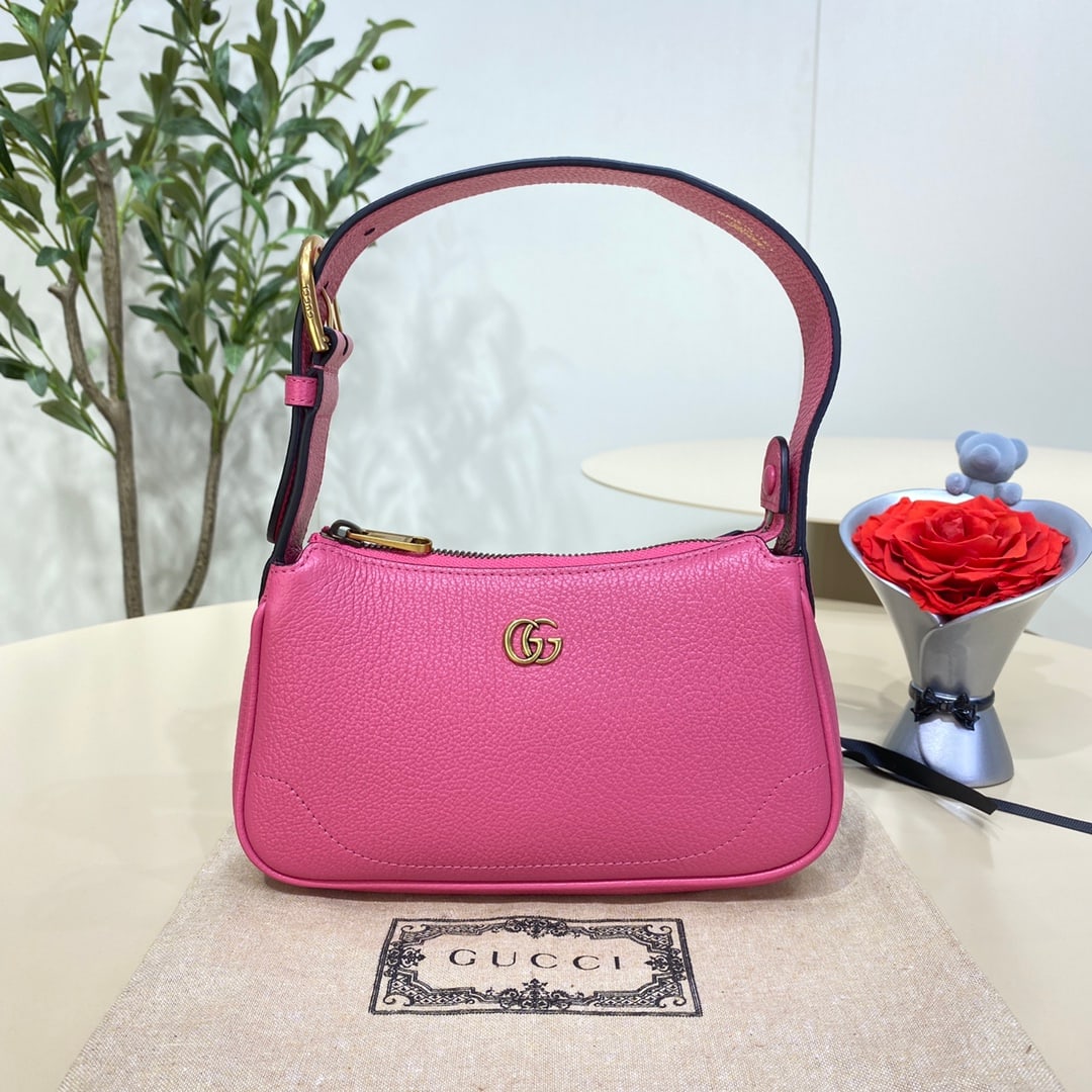 GUCCI Aphrodite: The GUCCI Aphrodite mini shoulder bag in fuchsia pink pays homage to the popular styles of the late 1990s and early 2000s, reinterpreting them with a fresh silhouette. It blends classic design with