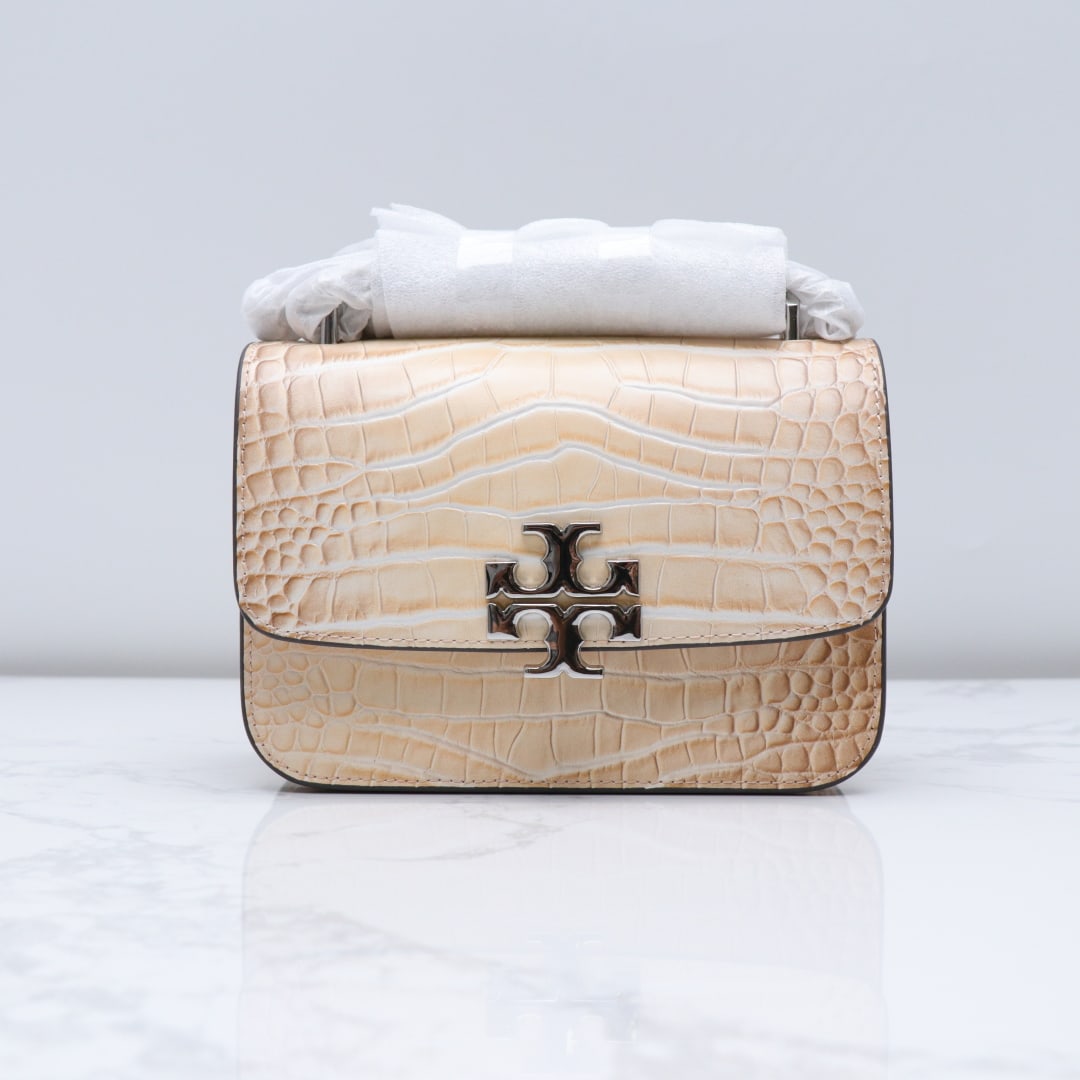 TB: This small TB flap shoulder bag features a magnetic snap closure, chain shoulder strap, and multiple pockets. The stylish flap closure is adjustable, and it includes an interior front pocket, an inter