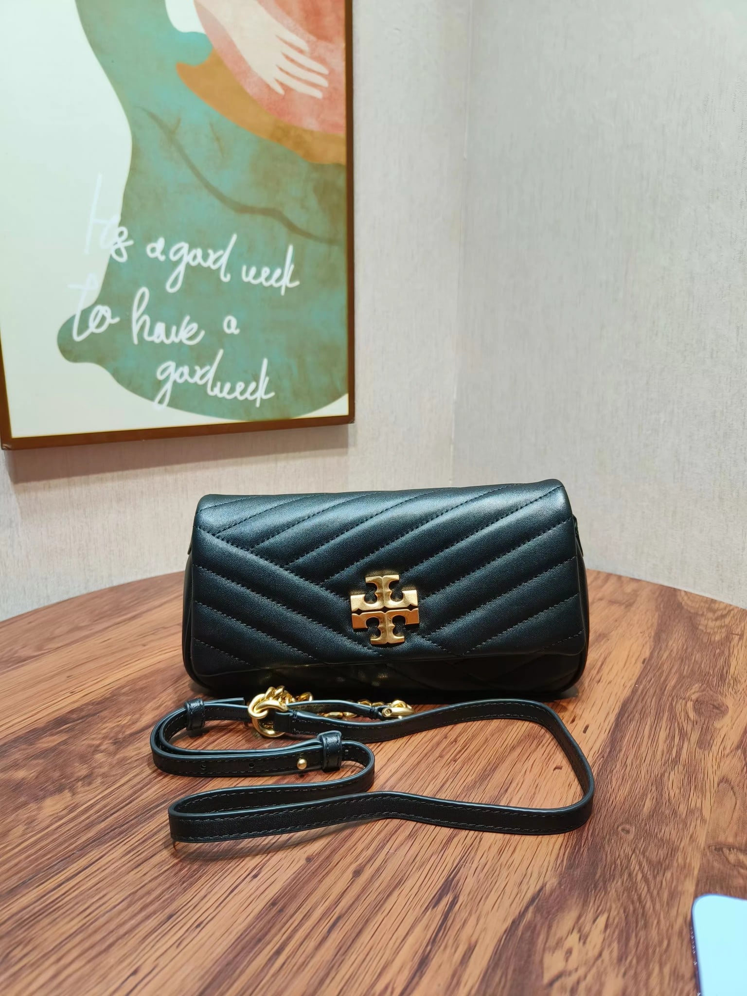 TB Kira: The Kira shoulder bag is lightweight and easy to carry under the arm. Crafted from select herringbone quilted leather, it features tan brass hardware: the iconic slanted double-T logo and a