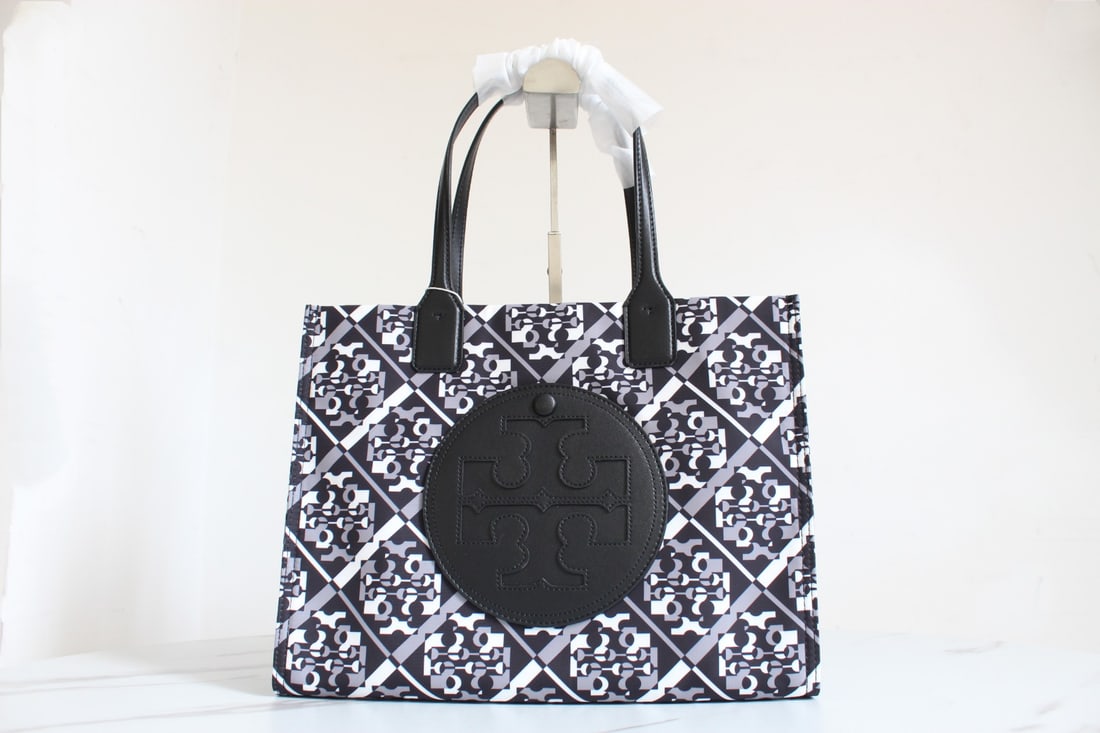TB Ella: ToryBurchElla Print Shopping Bag, a lightweight tote bag featuring a chic double-T logo patchwork design. Each season, classic prints are cleverly incorporated, creating a limited-edition design. With