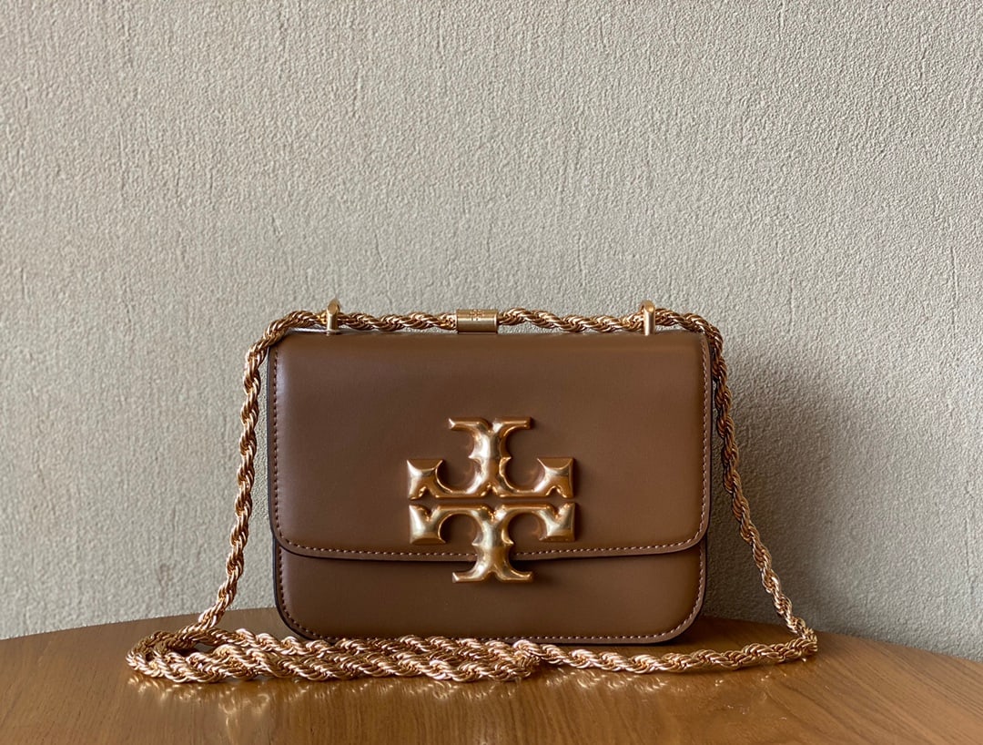 TB ELEANOR SAMLL CONVERTIBLE SHOULDET BAG: The apricot-colored TB ELEANOR SAMLL CONVERTIBLE SHOULDET BAG is a classic box bag, undoubtedly a beautiful and practical style with a sturdy body. The distressed hardware adds a vintage feel, and the