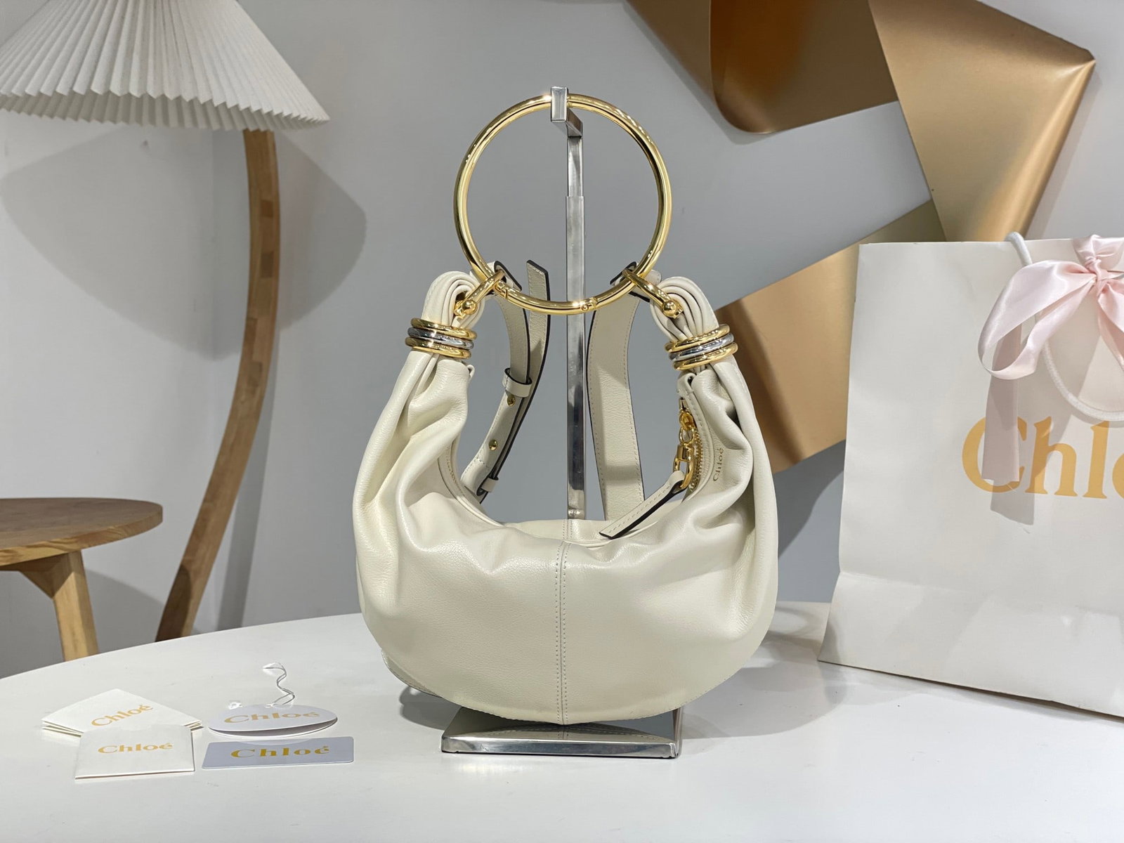 Chloe Bracelet Bracelet Bag: The Chloe Bracelet bag in white is a fall favorite, worn by numerous celebrities. Continuing its classic style, it can be worn crossbody or carried by hand, exuding femininity when carried by hand and