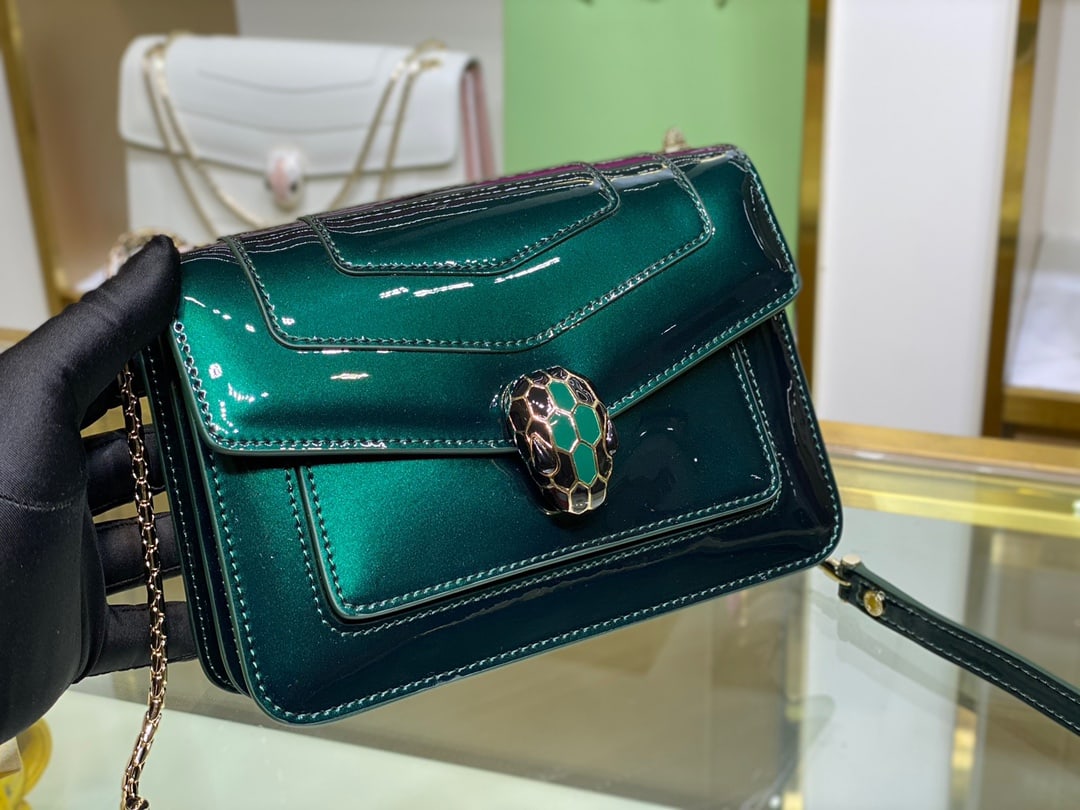 Bvlgari Serpenti Forever: The Serpenti Forever crossbody bag is stylish and versatile. This bag is crafted from emerald green calfskin with a pearlescent lacquer finish, adorned with matte green enamel accents and black onyx. 