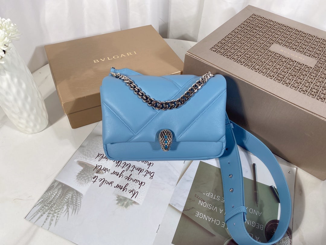 Bvlgari Serpenti Cabochon: The Bvlgari Serpenti Cabochon crossbody bag features a captivating oversized graphic pattern and bold metallic details. The body of the bag is crafted from supple Niagara sapphire blue calfskin, drawi