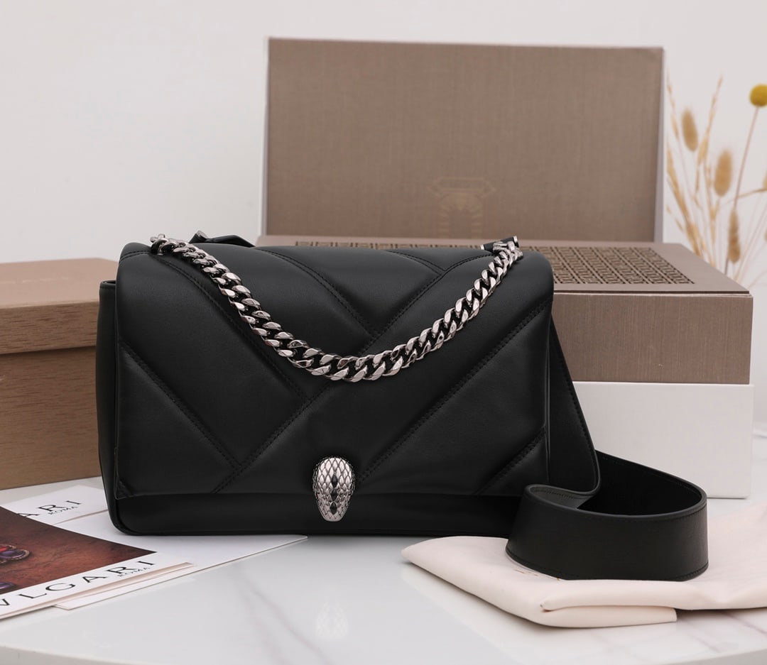 Bvlgari Serpenti Cabochon: The Bvlgari Serpenti Cabochon crossbody bag features a captivating oversized graphic pattern and bold metallic details. The black calfskin body of the bag is supple and smooth. The Serpenti snakehead 