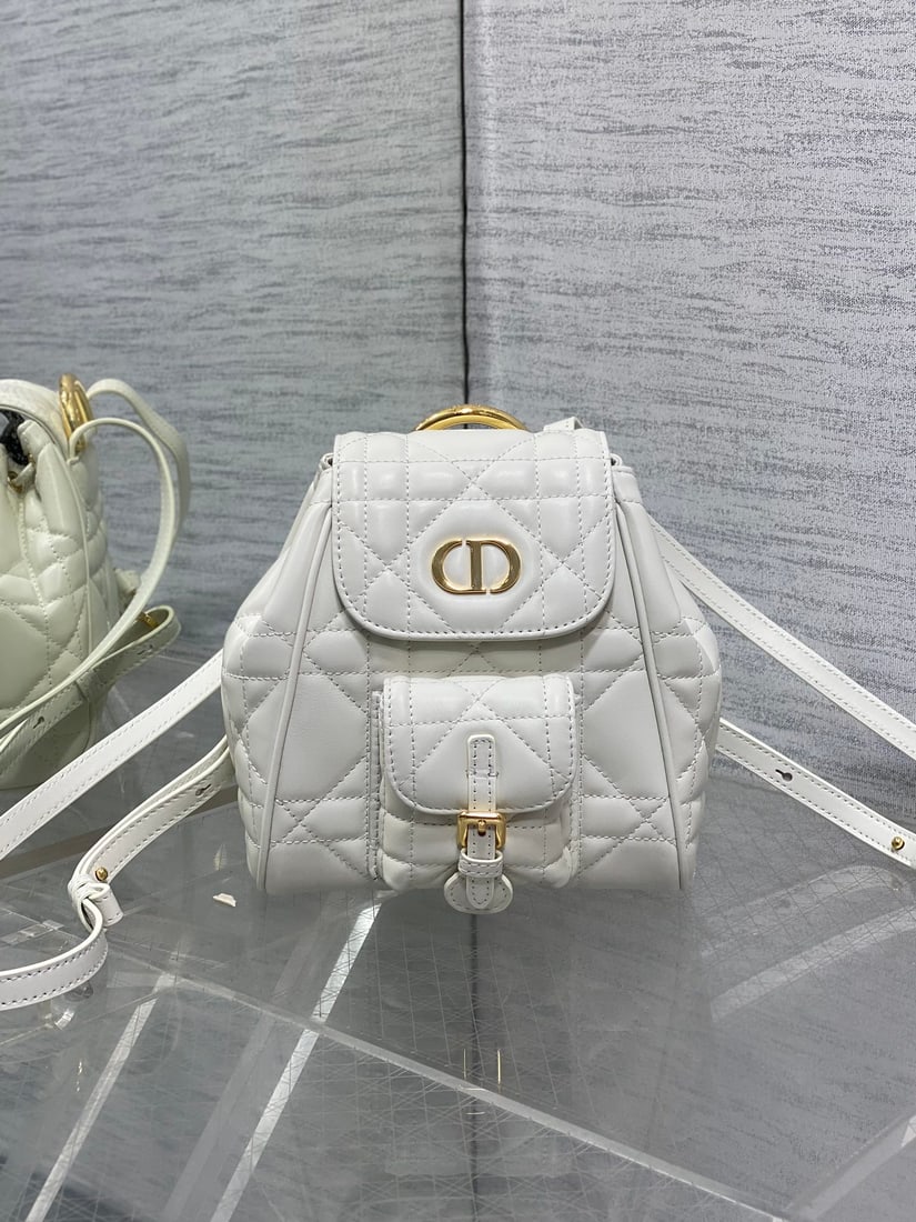 Dior Miss Caro: Caro's Fall Winter Small Backpack is this season's hottest bag, featuring classic elements: the iconic logo, a large cannage pattern, and a vintage gold handle that elevates its style. Made of supple 