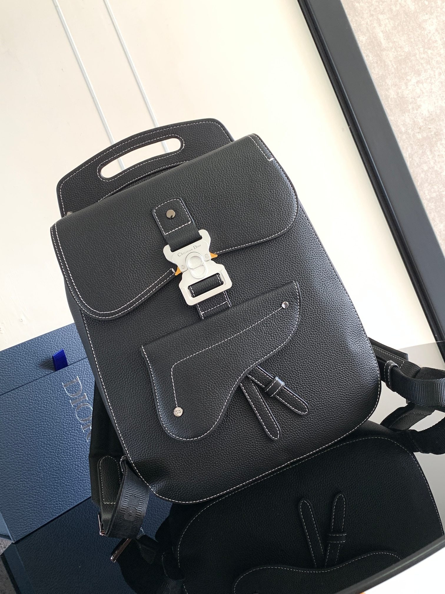 Christian Dior Gallop: The Gallop backpack features a stylish, original design that highlights the classic saddle style. Black grained calfskin leather is finished with contrasting stitching, and a Christian Dior logo-embel