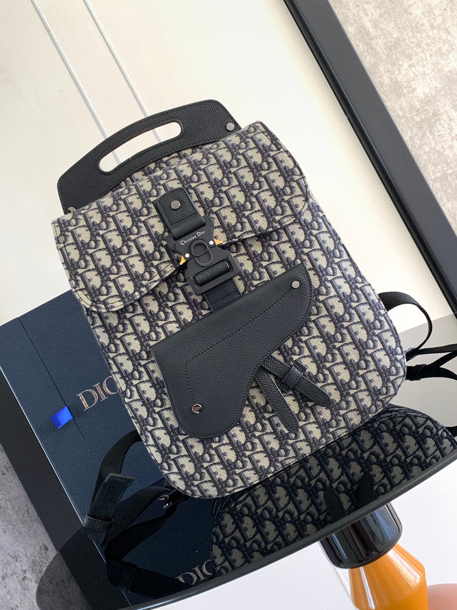 Christian Dior Gallop: The Gallop backpack features a stylish, original design that highlights the classic saddle style. Crafted from beige and black Oblique printed fabric, it's finished with black grained calfskin details