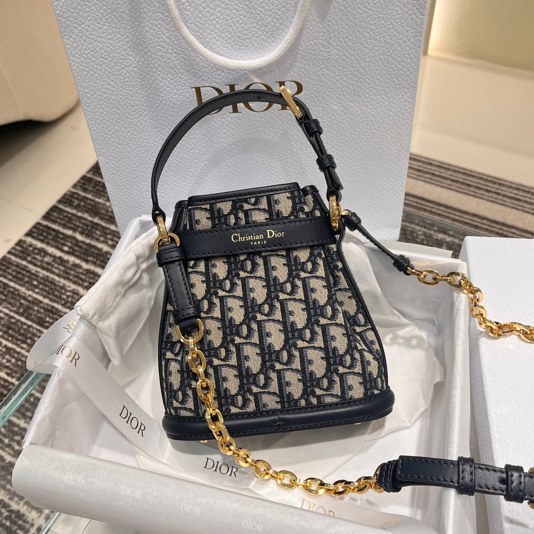 Christian Dior C'est Dior Bucket Bag: C'est Dior Small Bucket Bag: A relaxed and effortless style. Exclusive hardware with a rotating D-shaped clasp, showcasing exquisite details and a sophisticated, elegant, and artistic feel. Dimensions