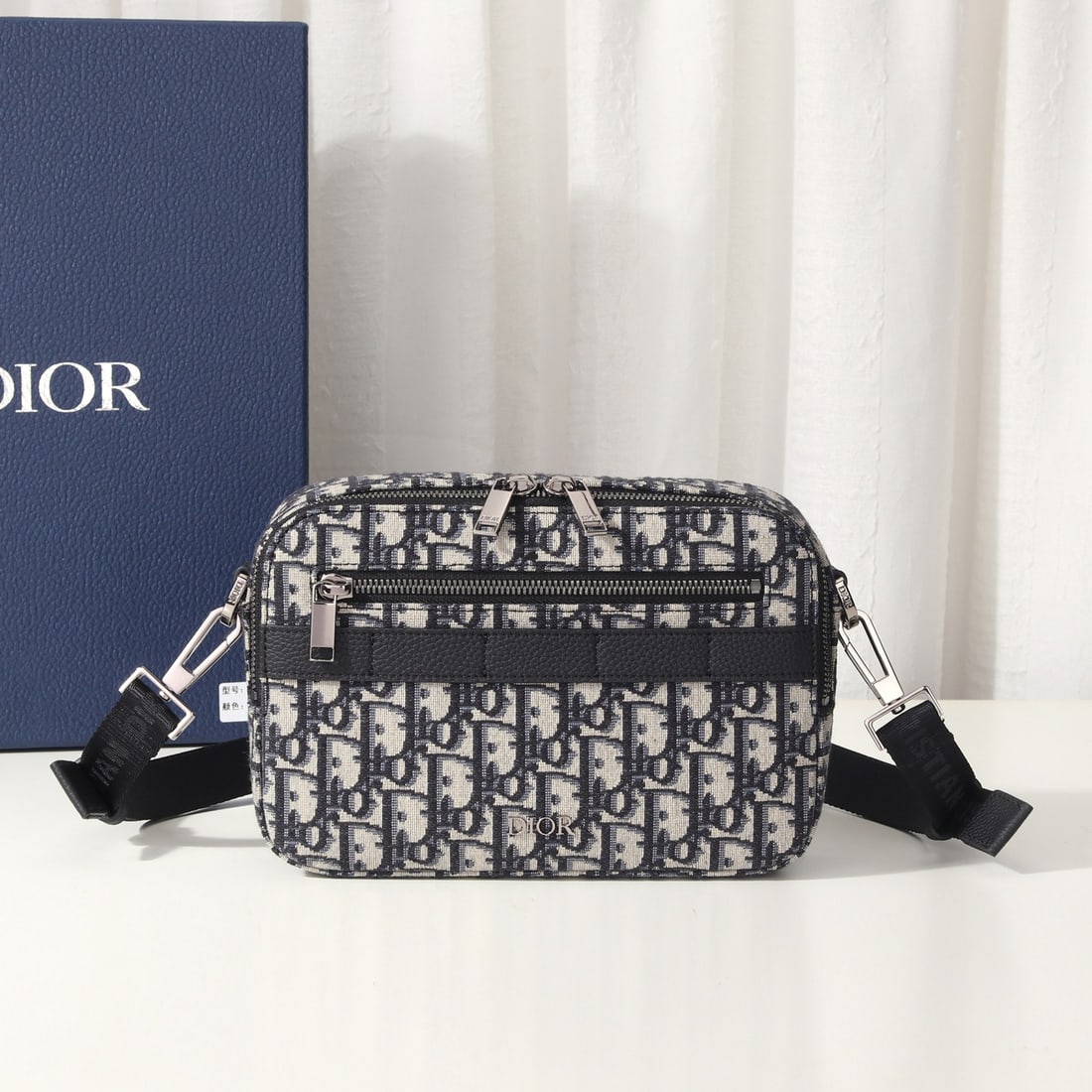 Christian Dior Safari: The Safari messenger bag is practical and compact, making it an ideal everyday carry item. Crafted from beige and black Oblique printed fabric with black grained calfskin details, it features a zipper