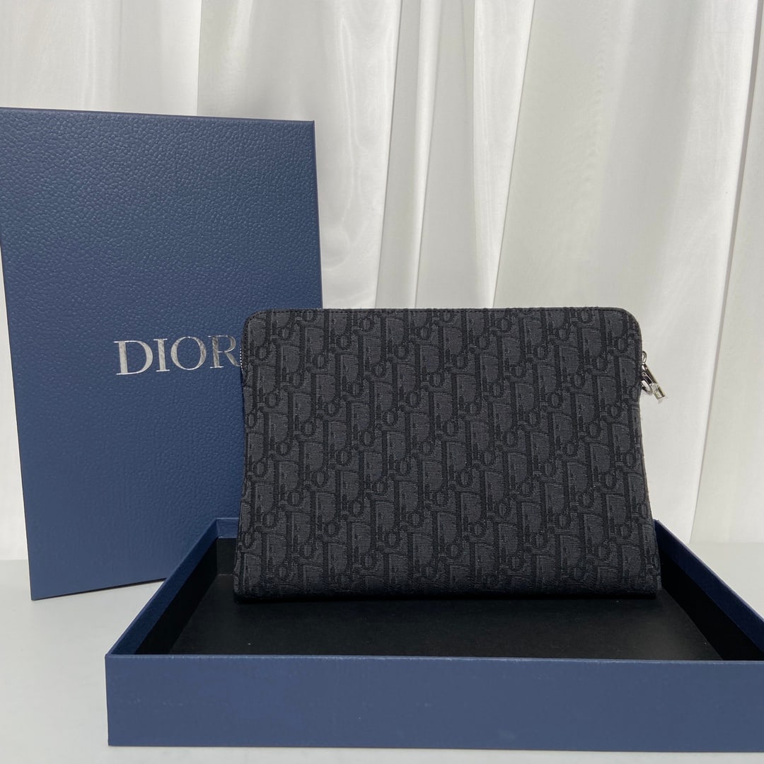 Christian Dior: This DIOR clutch features the iconic Oblique print, a classic pattern reminiscent of its 1967 debut. Crafted from jacquard fabric, it's adorned with the DIOR logo on the front. Made of smooth calfskin