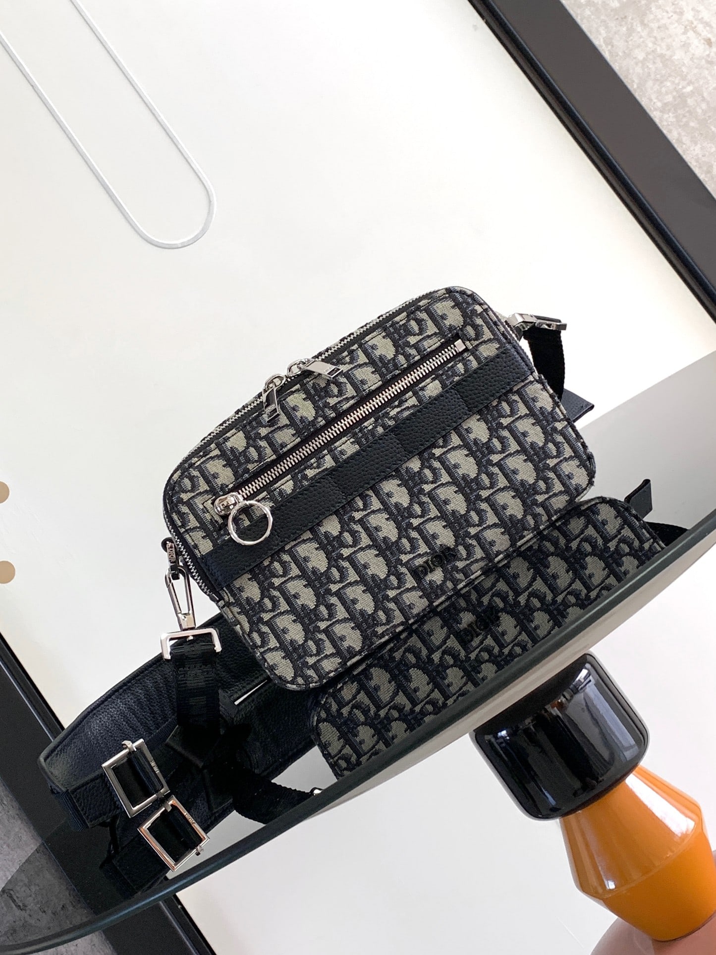 Christian Dior: The Safari messenger bag is practical and compact, making it an ideal everyday carry item. Crafted from beige and black Oblique printed fabric with black grained calfskin details, it features a zipper