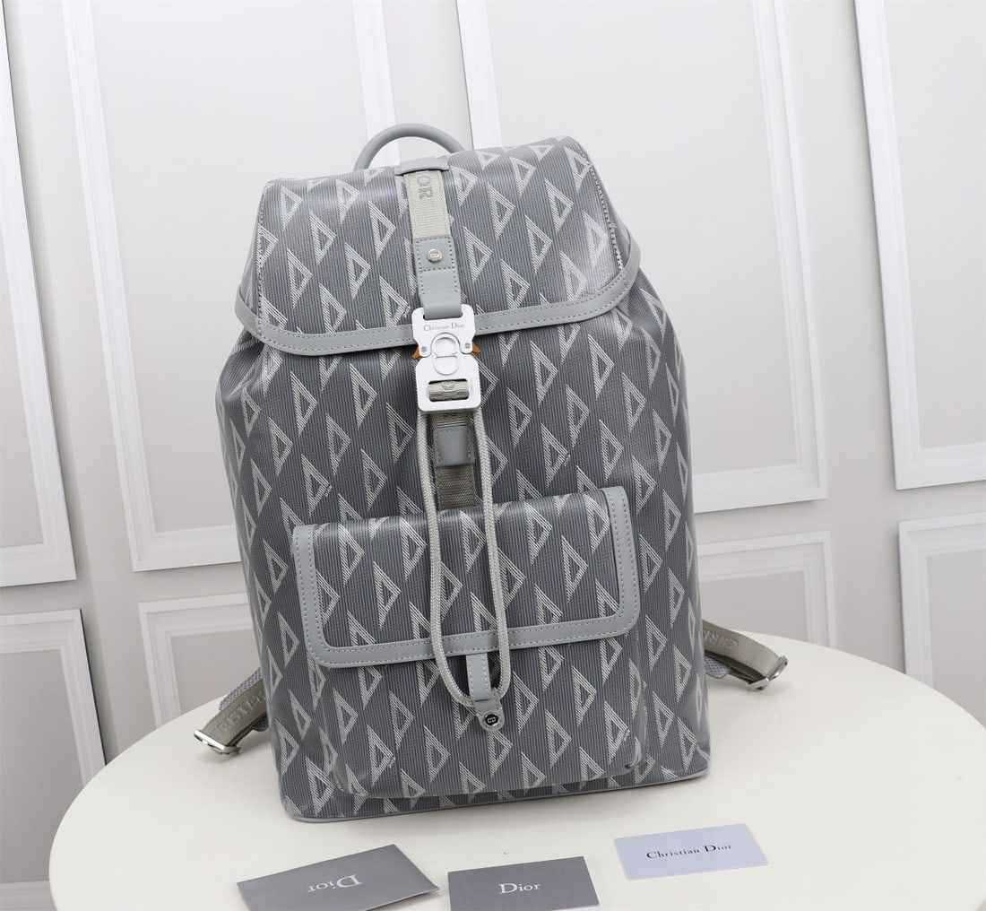 Christian Dior: The Dior Hit the Road backpack seamlessly blends modern style with Dior's haute couture spirit. Crafted from black CD Diamond patterned canvas, it draws inspiration from the Dior archives and is adorn