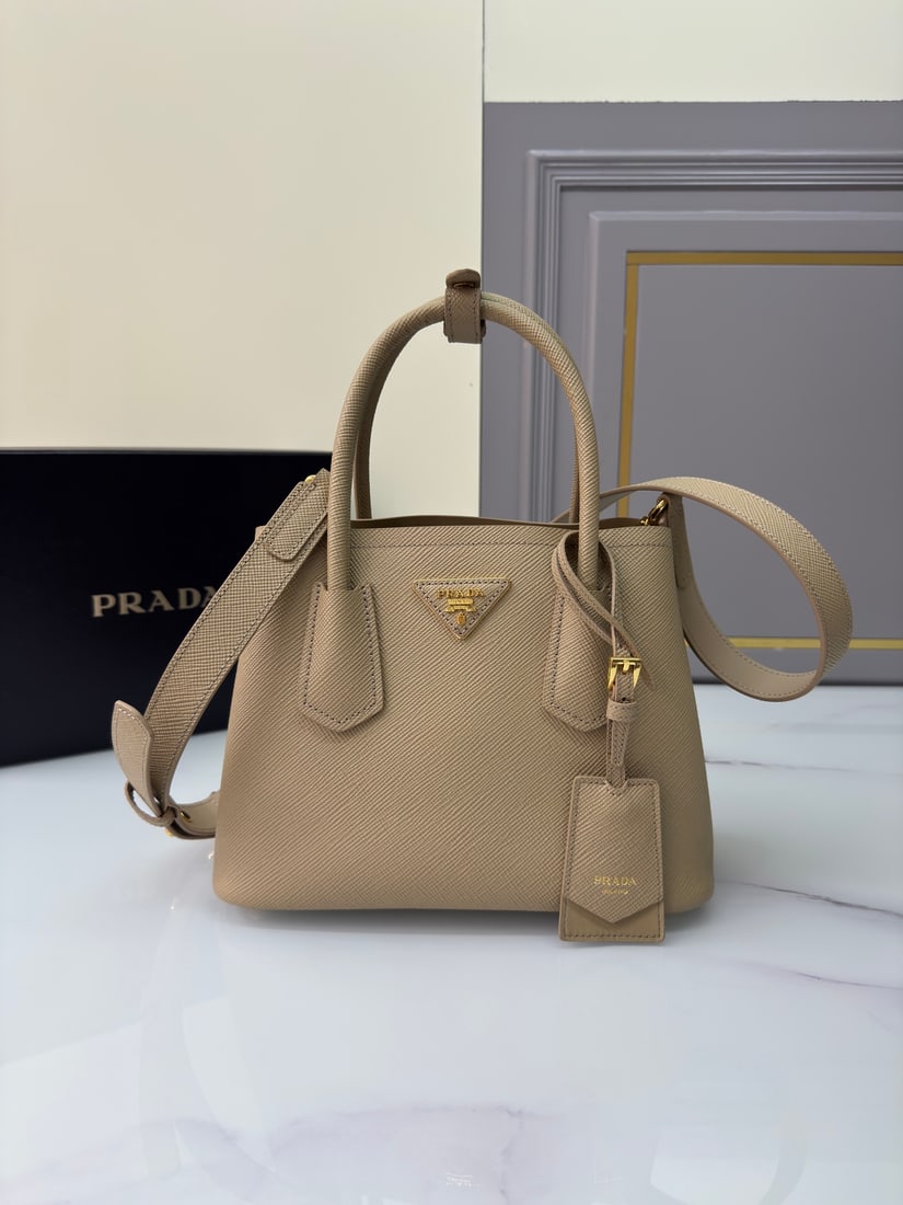 PRADA Double Bag mini shopping bag: DoubleBag mini shopping bag. Inspired by the Double series, this mini bag is made of imported coarse cross-grain cowhide leather with a full sheepskin lining. The elegant and simple design features a 