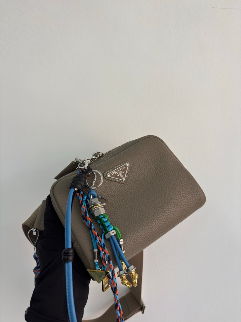 PRADA chest bag: This leather chest bag shoulder bag features a stylish, flowing design and a layered silhouette. The adjustable webbing is made of imported deerskin and cowhide leather. It offers a comfortable and lu