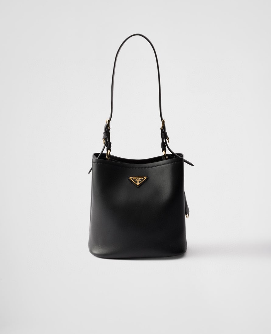 PRADA bucket bag: This bucket bag, made of leather, boasts soft lines and exquisite design, highlighting classic style and handcrafted details. Practical and versatile, it features an enamel triangular metal logo for a
