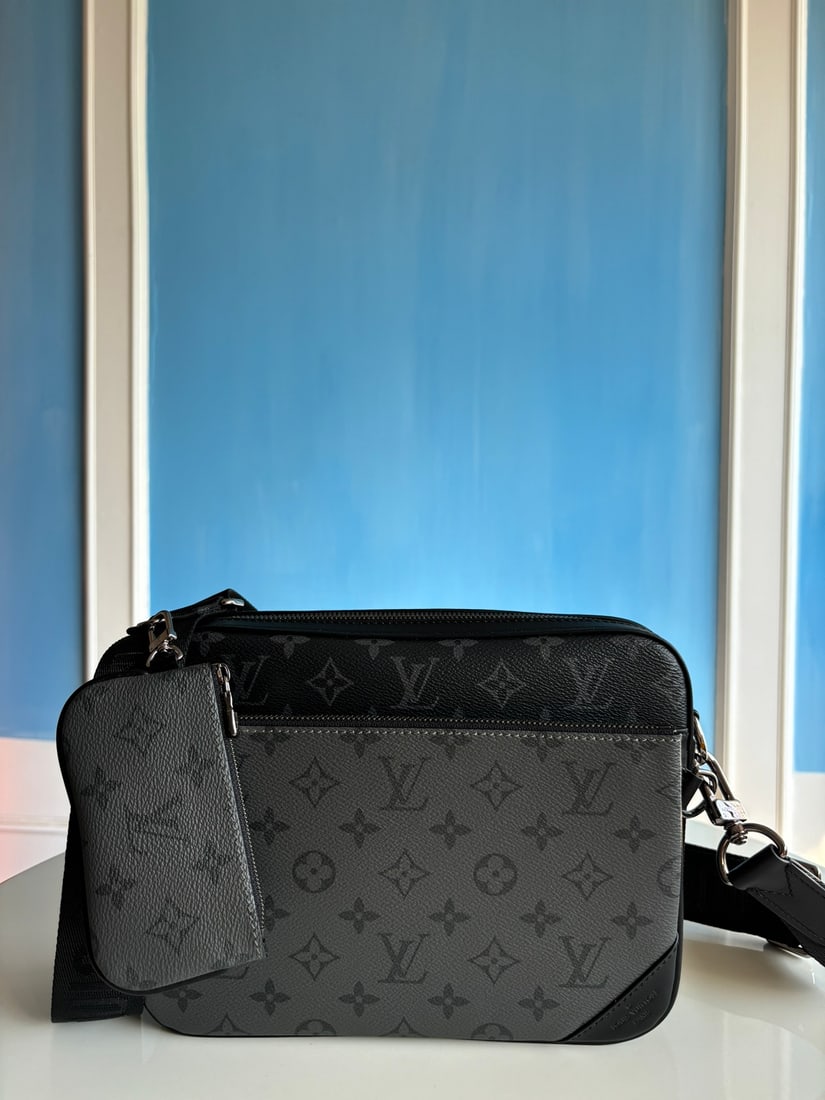 LV Trio messenger bag: The Trio messenger bag is crafted from Monogram Eclipse canvas and Monogram Eclipse Reverse canvas. The iconic tonal pattern accentuates the lines of this versatile patchwork design. In addition to it