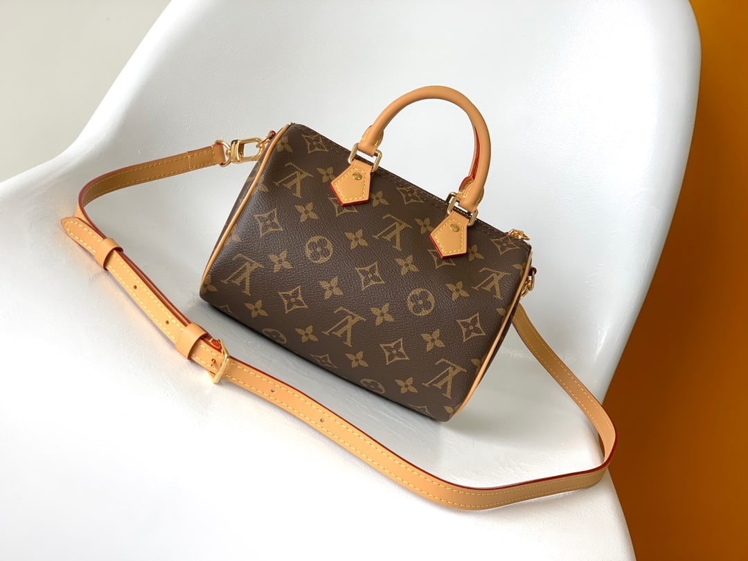 LV Speedy BandouliEre 20: The Monogram Canvas Speedy BandouliEre 20 handbag, crafted from Monogram canvas with calfskin trim and a fabric lining, continues the classic design of the LV Speedy travel bag in a compact size. It f