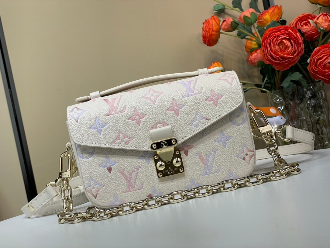 LV POCHETTE METIS EAST WEST: The Pochette METIS East West messenger bag is crafted from grained cowhide leather, with a digital printing process rendering the classic Monogram pattern in gradient watercolor hues, subtly highlight
