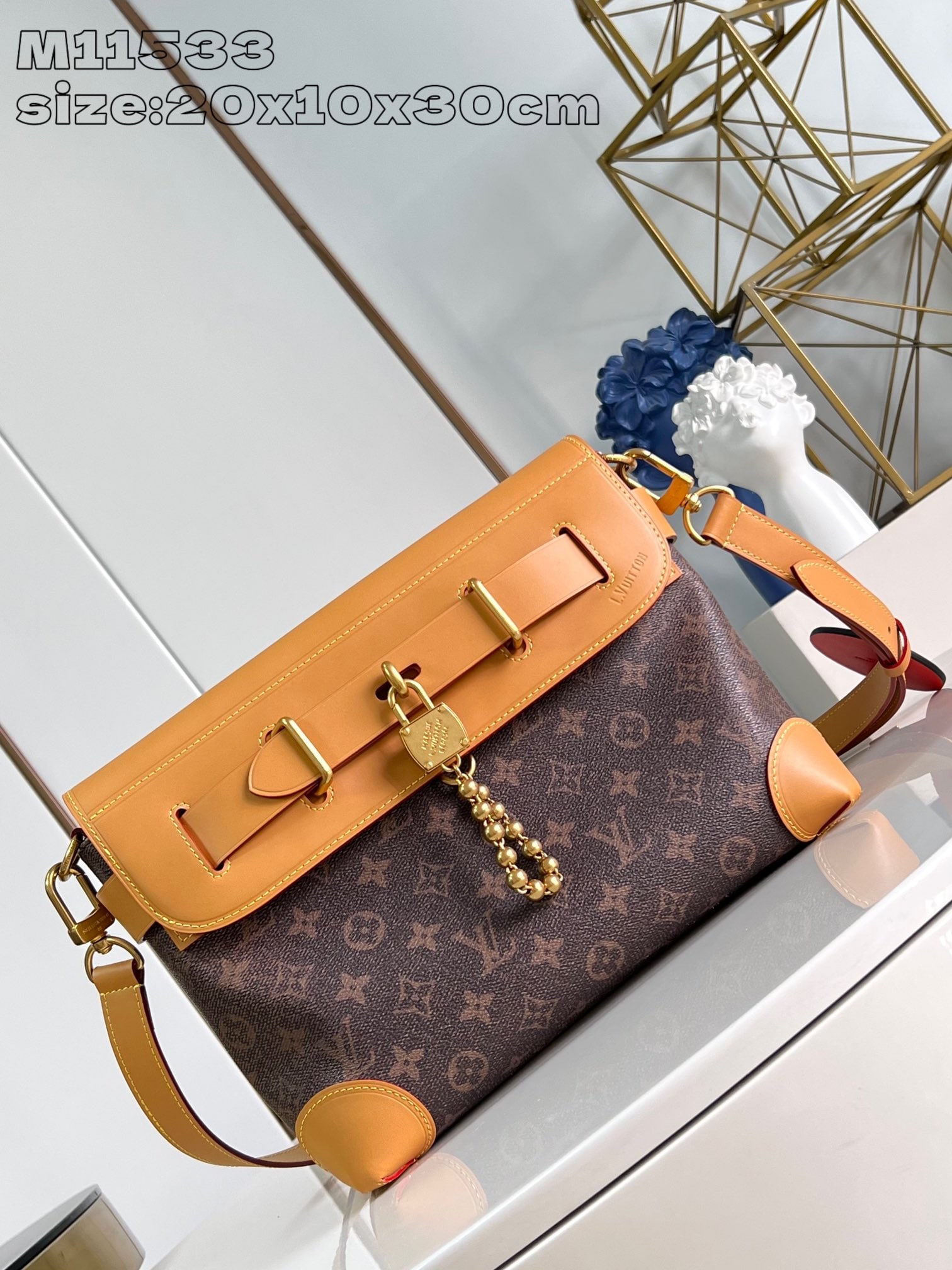 LV Steamer Crossbody: The Steamer Crossbody handbag, crafted from Monogram Dust coated canvas with distressed calfskin trim and adorned with a dazzling beaded chain hanging from a Louis Vuitton Marque DEposEe-inscribed pad