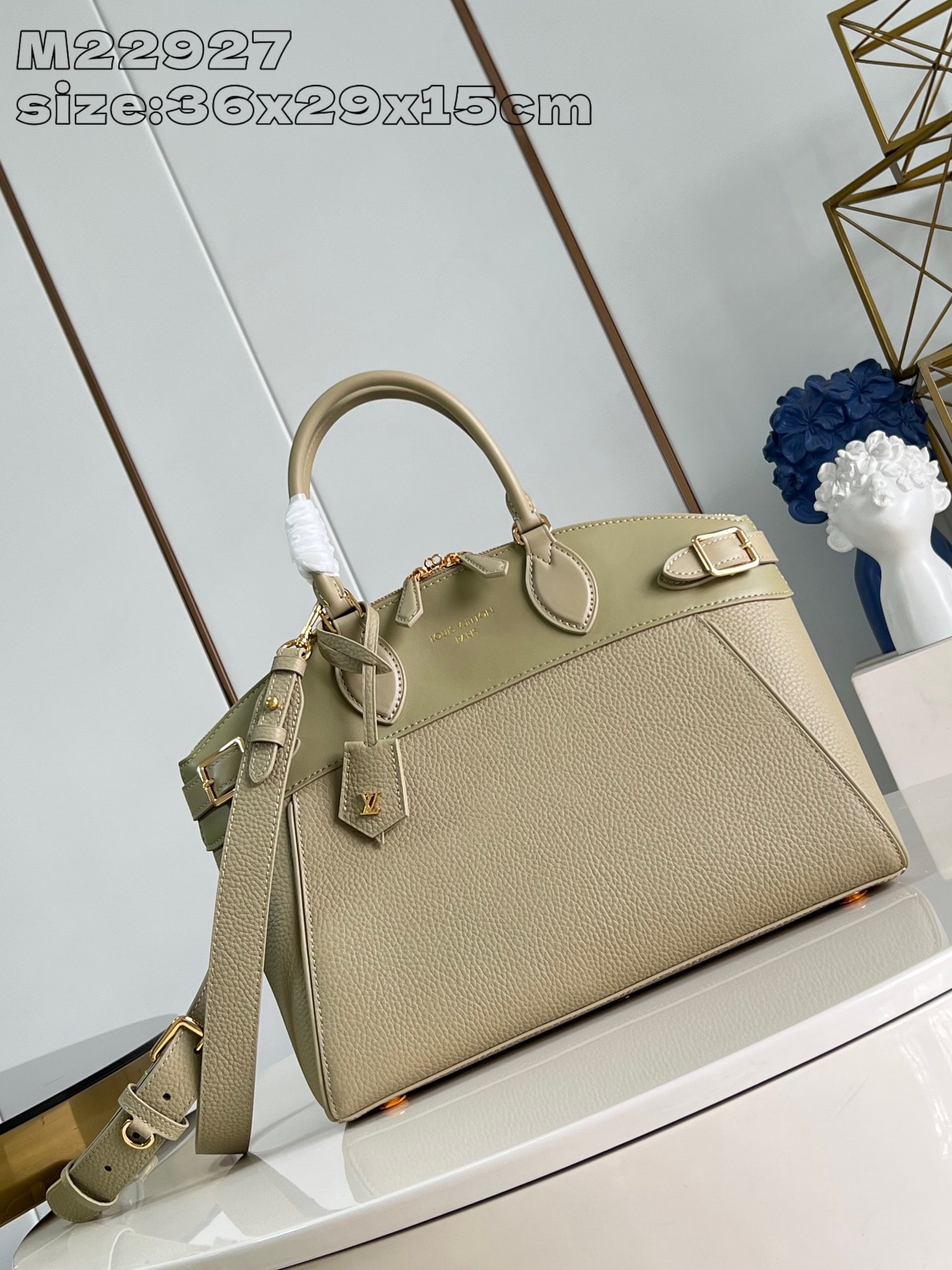 LV Lock It MM: This elegant and practical Lock It MM handbag combines grained Taurillon leather and smooth calfskin, accented with gold-tone buckles and metal hardware for a sophisticated look. The bag features clas