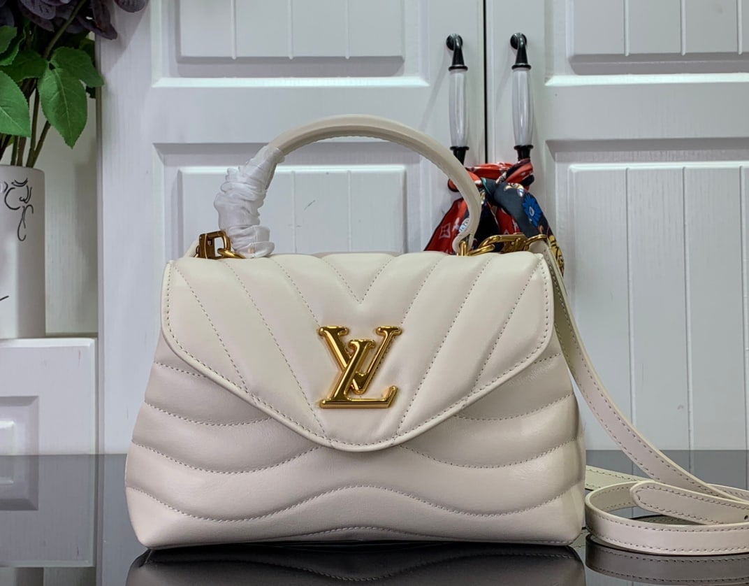 LV HOLD ME: The Hold Me handbag is a new addition to LV's iconic New Wave quilted leather goods collection. It boasts an exquisite design and comfortable carrying. The smooth-to-the-touch body is adorned with an 