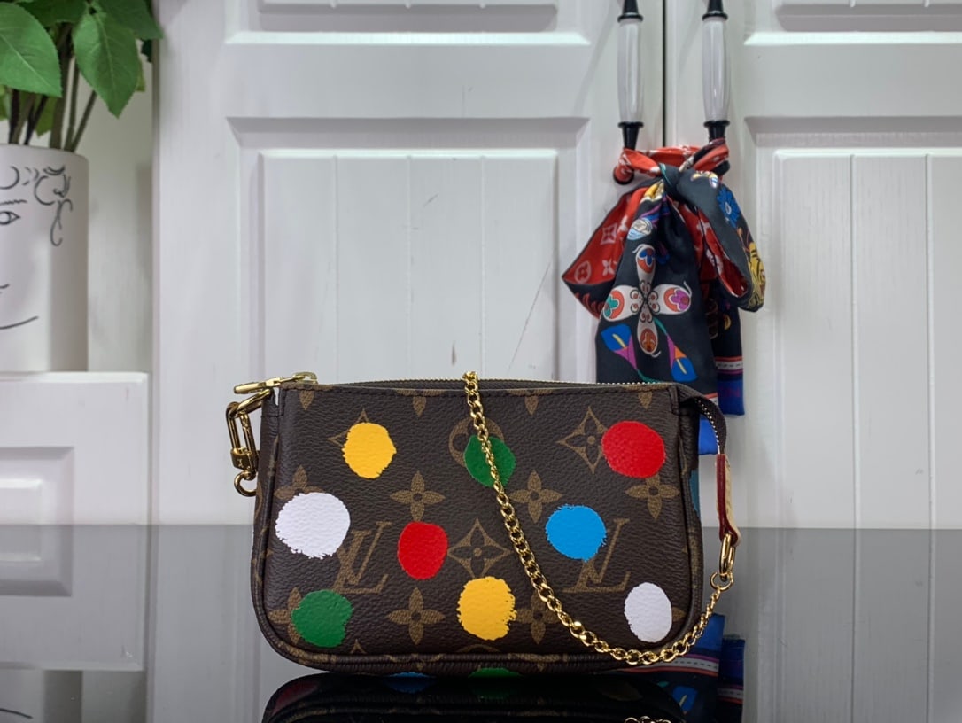 LV x YK Mini Pochette Accessoires: LV x YK Mini Pochette Accessoires reunite with Yayoi Kusama for the second installment of their collaborative collection. The Japanese artist, obsessed with polka dots throughout her life, uses them a