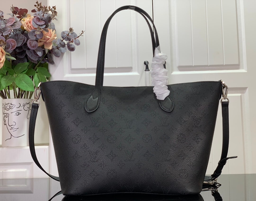 LV BLOSSOM: The BLOSSOM Medium Tote Bag is crafted from Mahina calfskin with delicate Monogram perforations. The soft, lightweight calfskin accentuates the design's drape, making it perfectly suited to the body. 