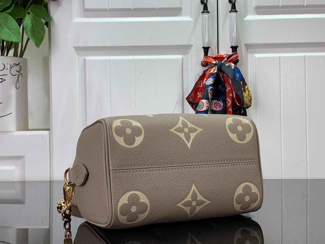 LV Speedy Bandouillere 20: The Speedy BandouliEre 20 handbag is crafted from two-tone Monogram Empreinte leather, adorned with the LV logo and Monogram floral pattern. A modern classic, this Speedy BandouliEre 20 bag draws insp